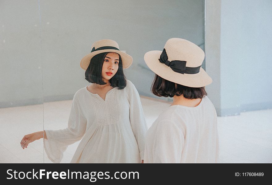 Woman Wearing White Long-sleeved Dress and Beige Sun Hat