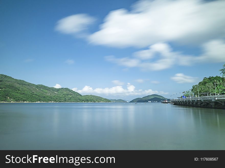 Body of Water Under White Clouds