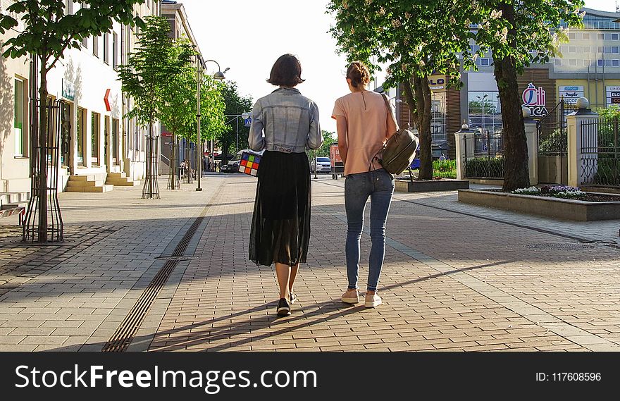 Photo of Women Walking Down the Street