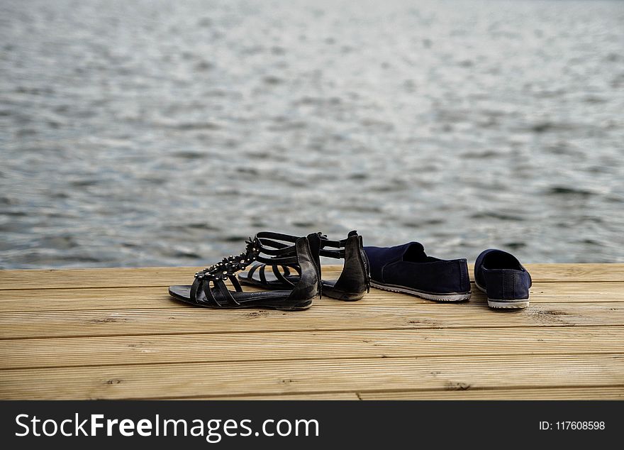 Two Pairs of Sandals on Wood Floor