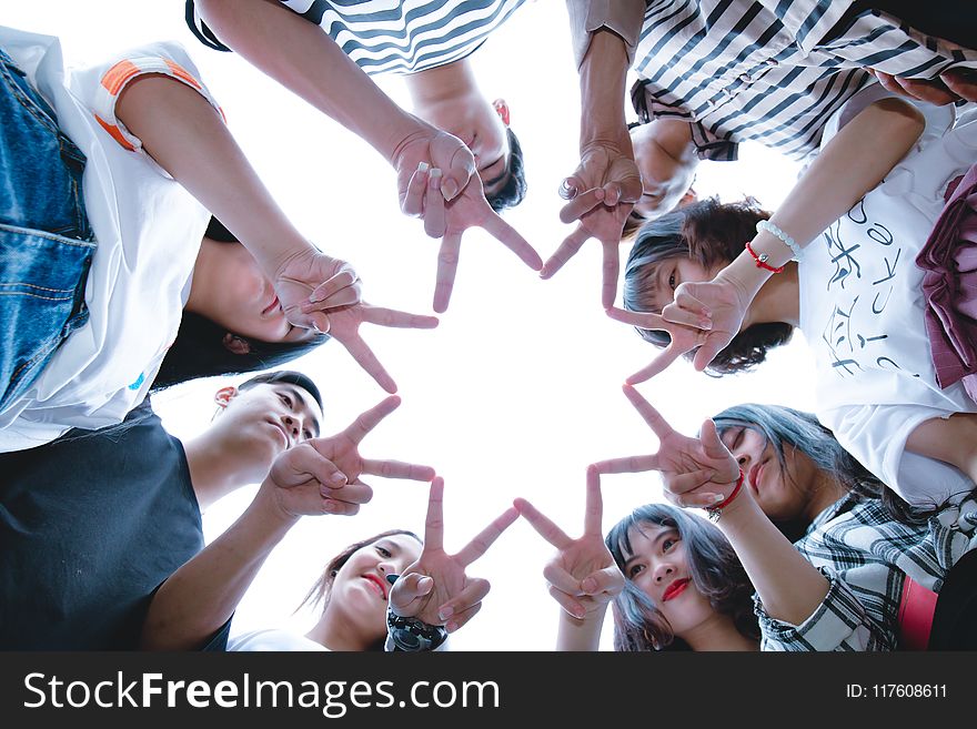 Group of People Forming Star Using Their Hands
