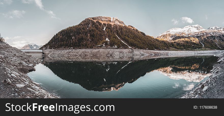 Green Covered Mountain Reflected on Calm Water Under Clear Sky Landscape Photo