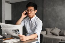 Emotional Young Asian Man Talking By Phone Royalty Free Stock Photo