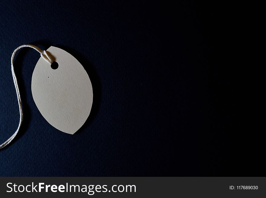 White Tag With String and Black Background