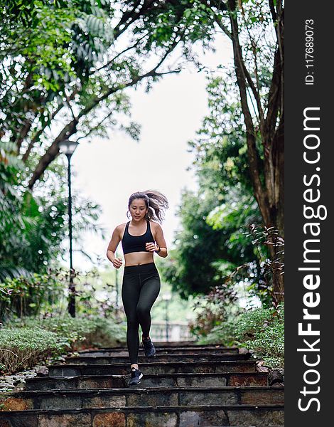 Photo of Woman Jogging Down Stairs