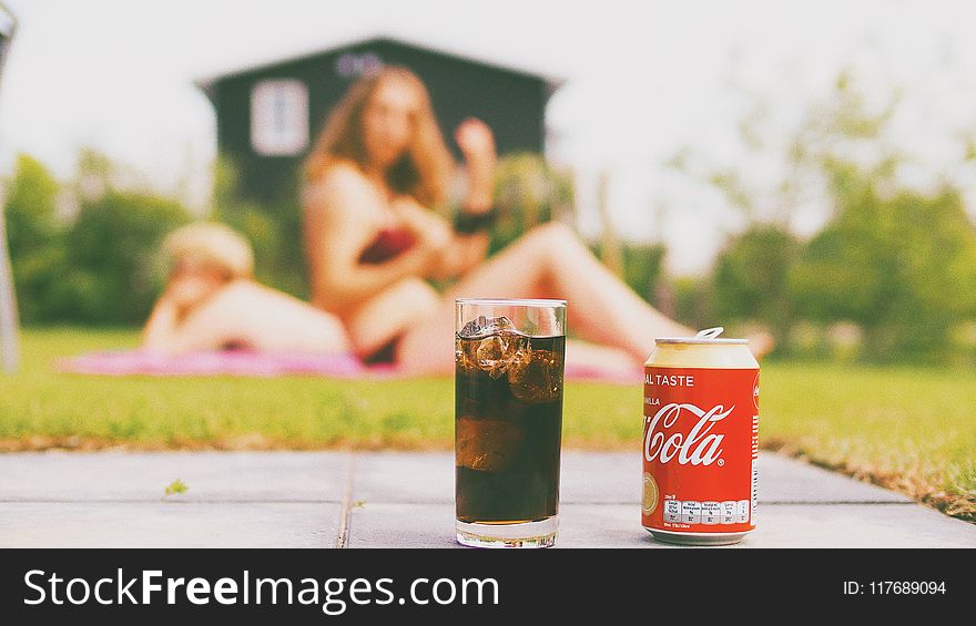 Coca-cola Can and Drinking Glass Filled With Coke