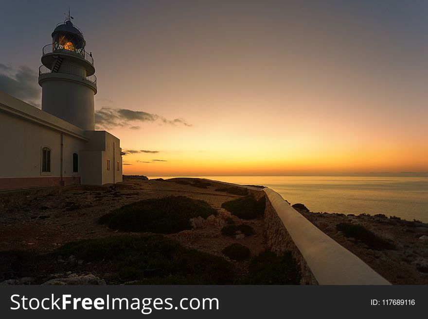 White Concrete Lighthouse during Golden Hour