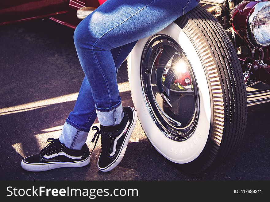Person Sitting On Vehicle Wheel