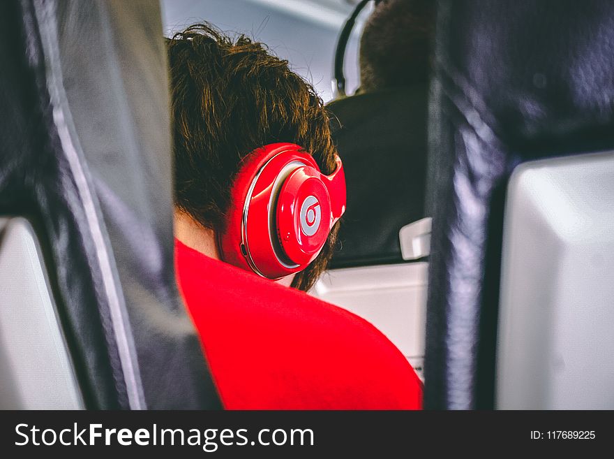 Man Wearing Red Beats By. Dre Headphones