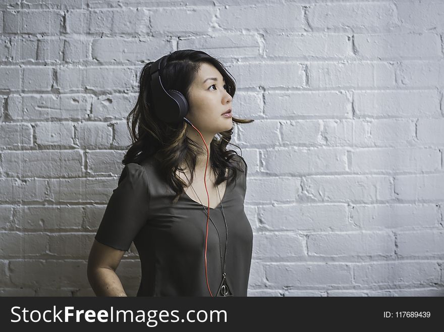 Woman Looking Up While Wearing Headphones