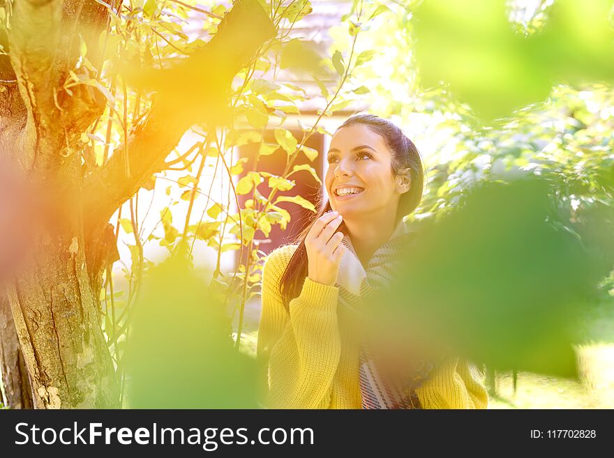 A beautiful woman eating wine grapes on a field