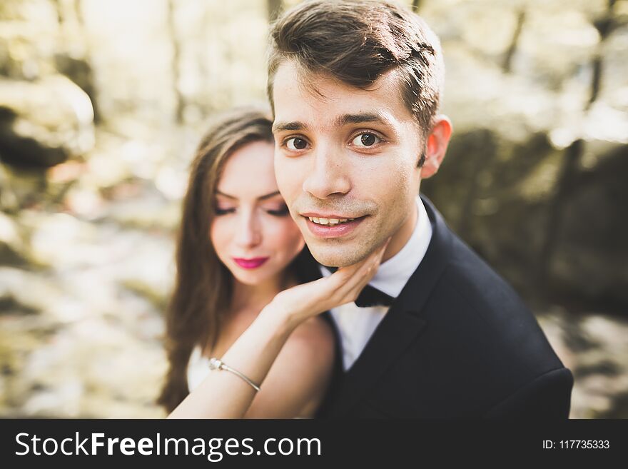 Beautiful, perfect happy bride and groom posing on their wedding day. Close up portrait.