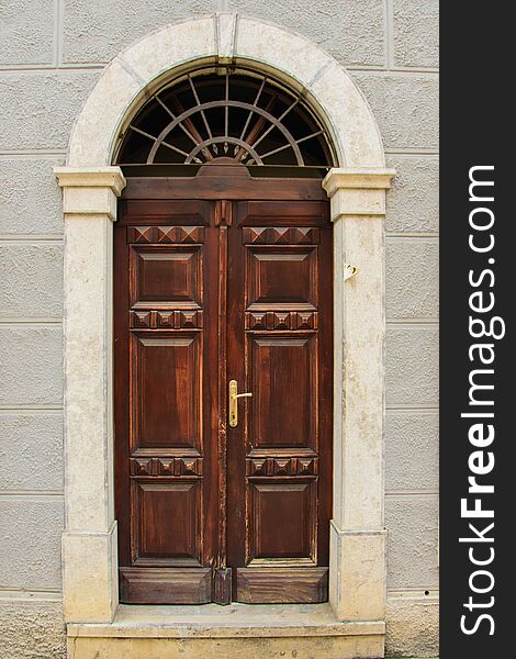 Front view of a wooden antique medieval door, part of an antique building