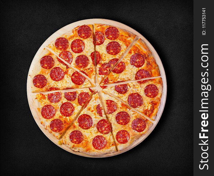 Pepperoni pizza on a black background.