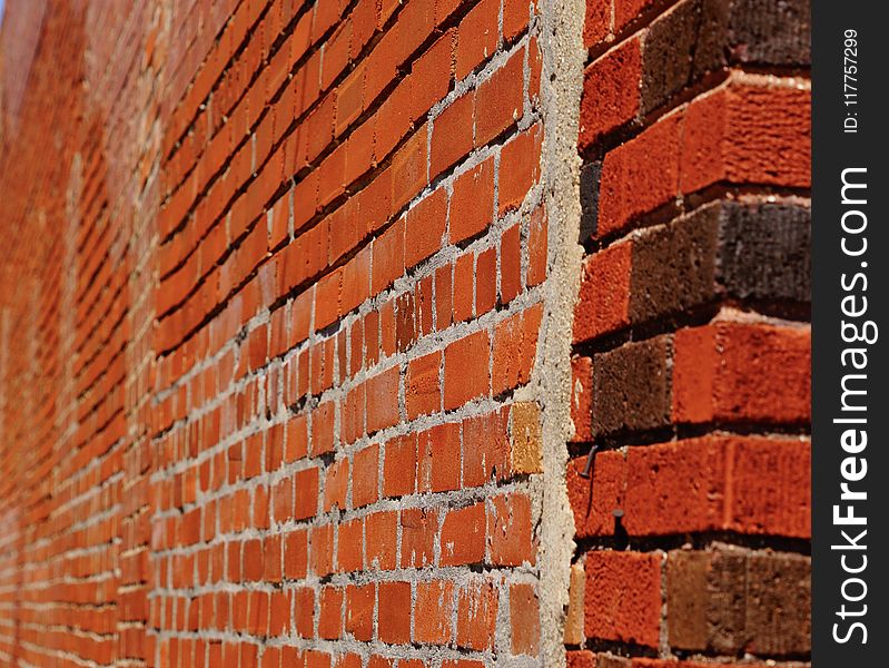 A photo of an old red brick wall showing blur and mortar. A photo of an old red brick wall showing blur and mortar.