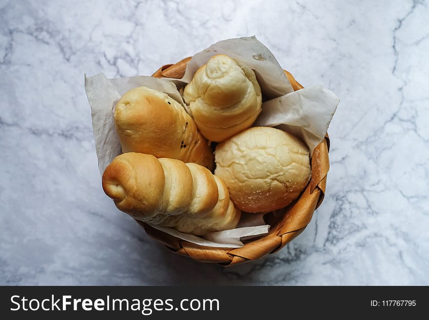 Four Brown Pastries in Brown Wicker Basket