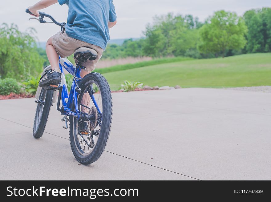 Person Riding Blue Bicycle