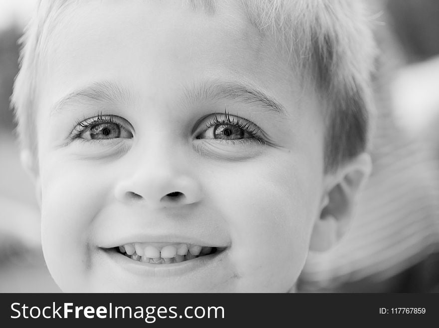 Grayscale Photo of Toddler Smiling