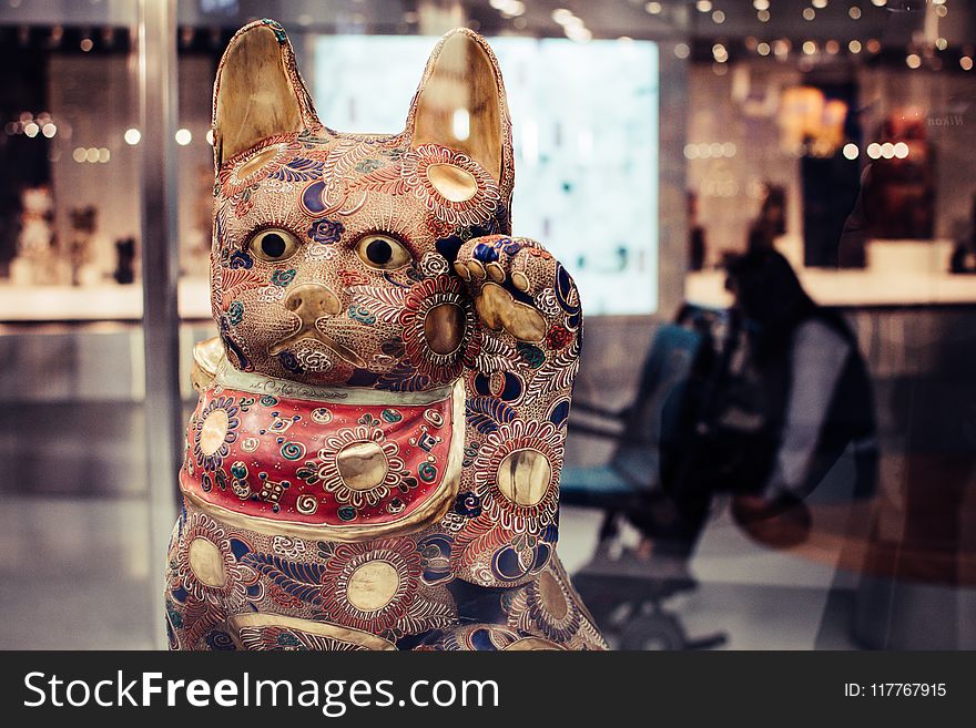 Shallow Focus Photography Of Maneki-neko Figurine