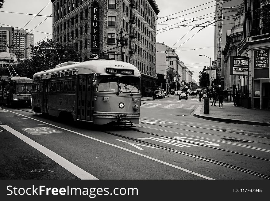 Grayscale Photography of Tram Near Buildings