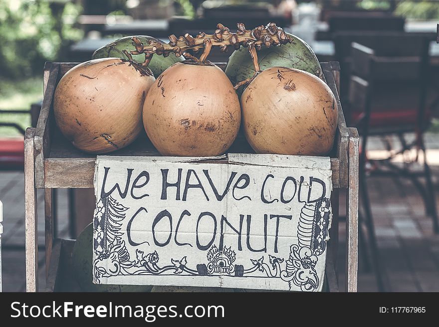 Tan Coconuts Placed Atop Brown Wooden Table