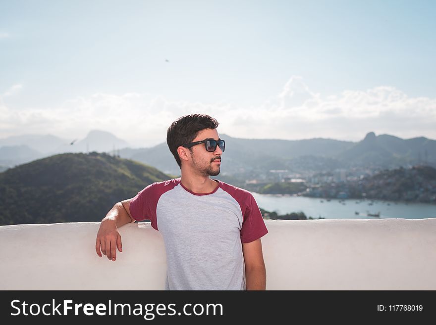 Man in White and Red Crew-neck T-shirt in Shallow Focus Photography