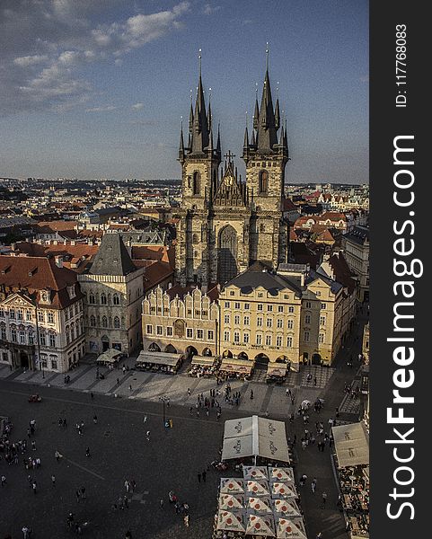 Church Surrounded By Buildings Under Blue Sky