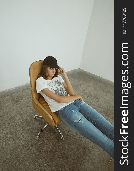 Woman Wearing White Printed Shirt Sitting on Brown Leather Rolling Chair