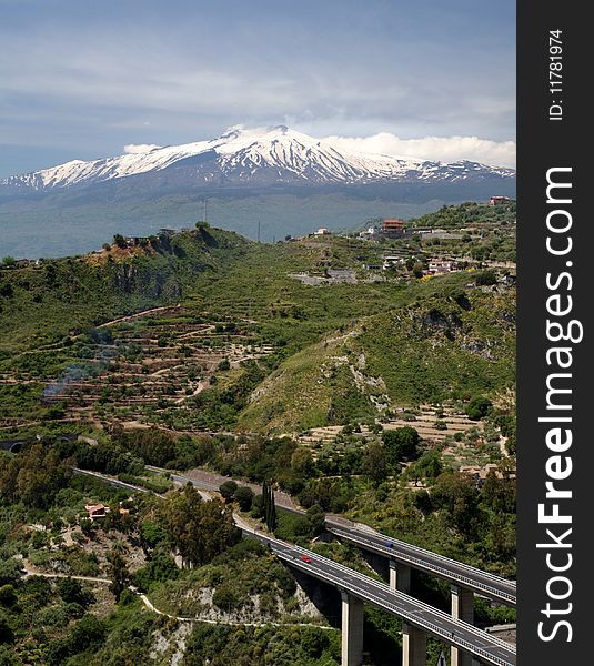 Mount Etna with a highway bridge in the foreground