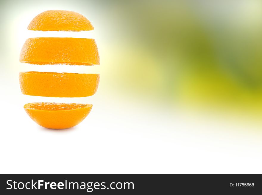 Sliced orange on white and green background