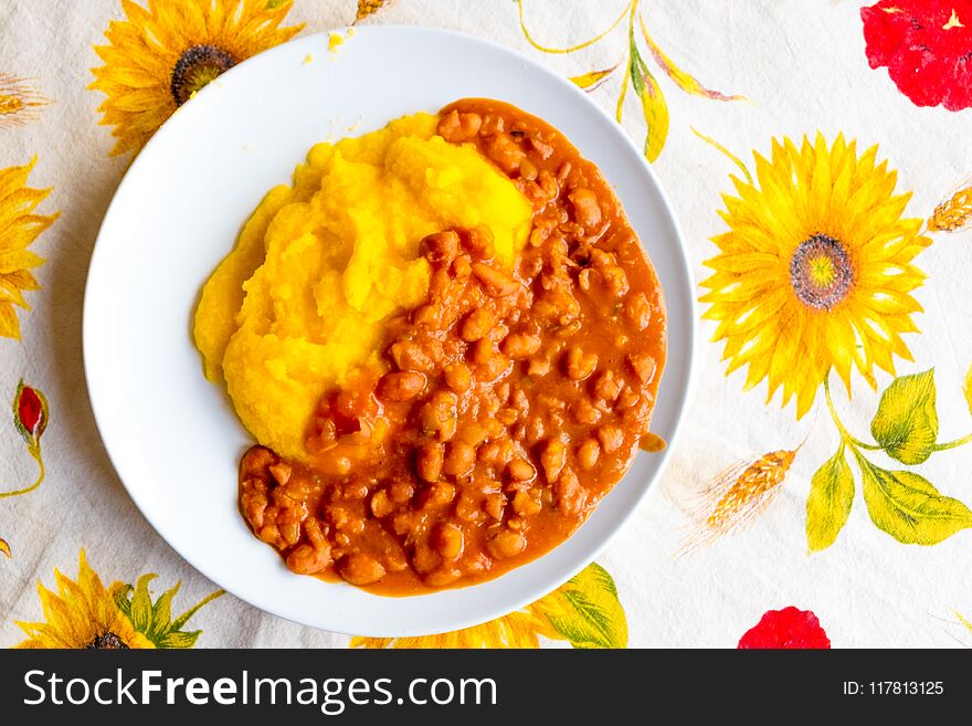 Traditional Italian poor dish with beans and polenta on tablecloth. Traditional Italian poor dish with beans and polenta on tablecloth