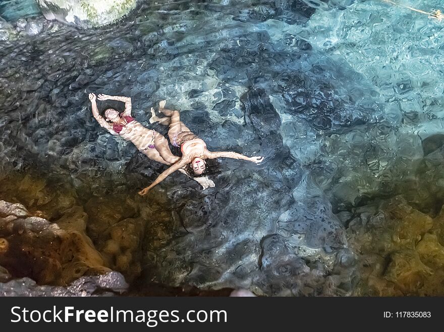 A beautiful hispanic brunette model enjoying a swim in a local cenote near Yucatan, Mexico. A beautiful hispanic brunette model enjoying a swim in a local cenote near Yucatan, Mexico.