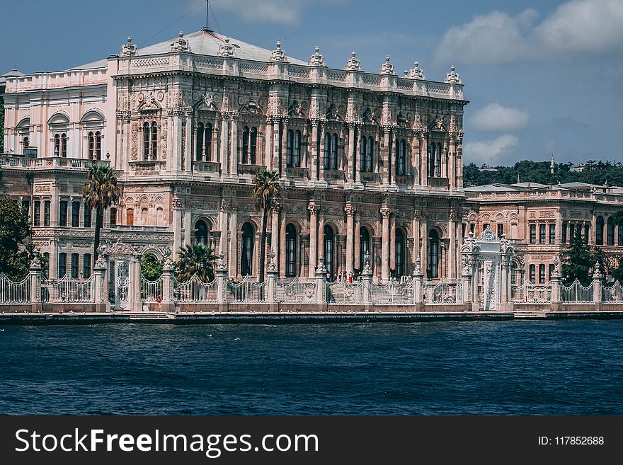 Photo Of Gothic Building Near Body Of Water