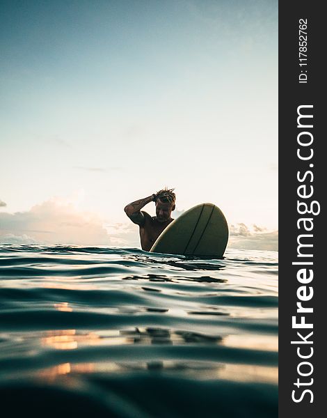 Man Holding White Surfboard