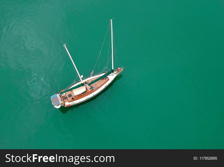 White Sailing Boat on Body of Water