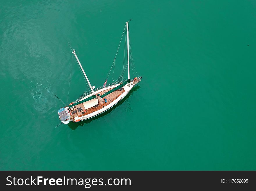 White Sailing Boat On Body Of Water