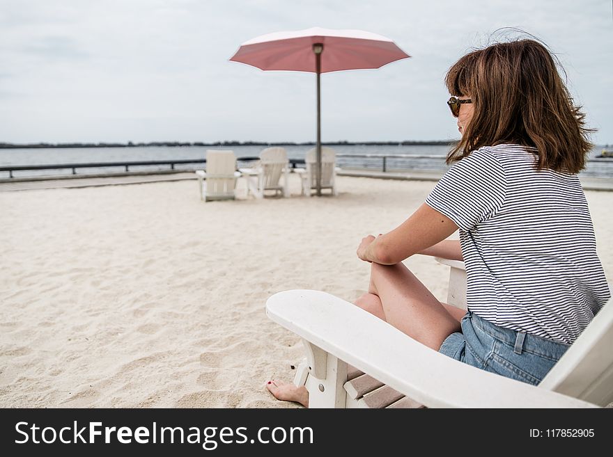 Woman sitting on beach chair