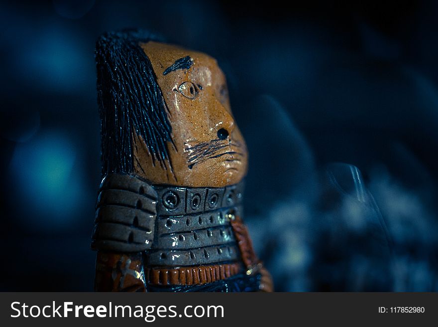 Brown and Gray Warrior Figure Closeup Photo