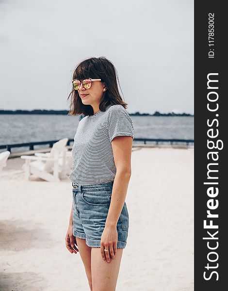 Smiling Woman Wearing Black And White Striped Shirt And Blue Short Shorts