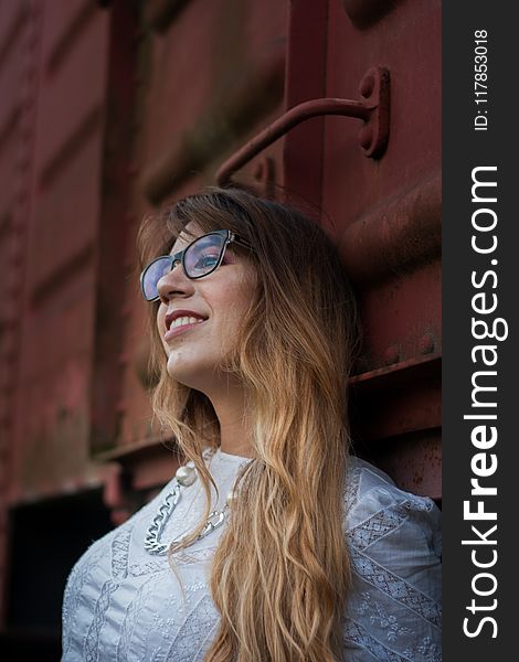 Woman In White Top Wearing Silver-colored Chain Necklace Leaning On Train