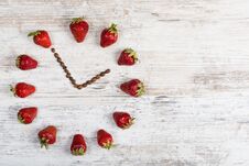 Strawberry Clock With Arrows From Coffee Beans Showing The Time Thirteen Hours Fifty-five Minutes Or One Hour Fifty-five Minutes O Stock Image