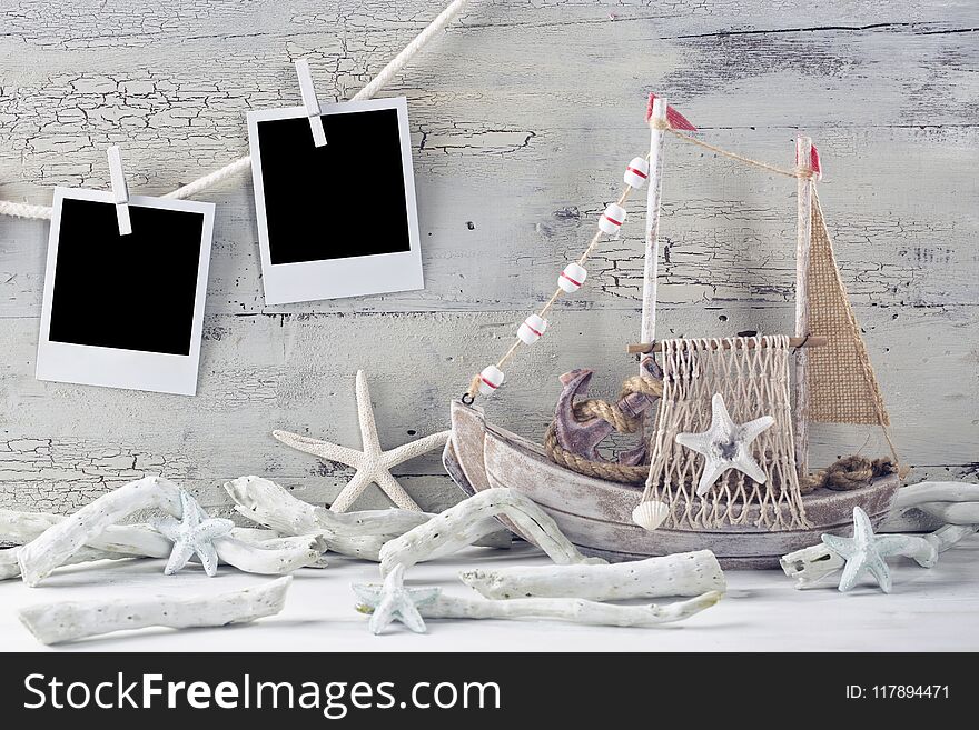 Marine life decoration and instant photos on a white shabby background