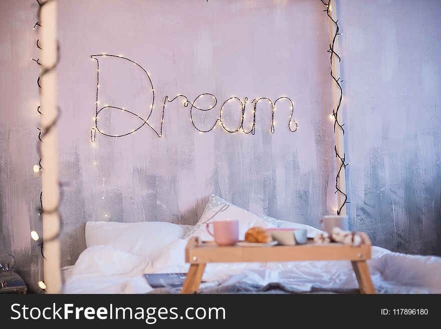 Beautiful photozone with a big bed and the word Dream