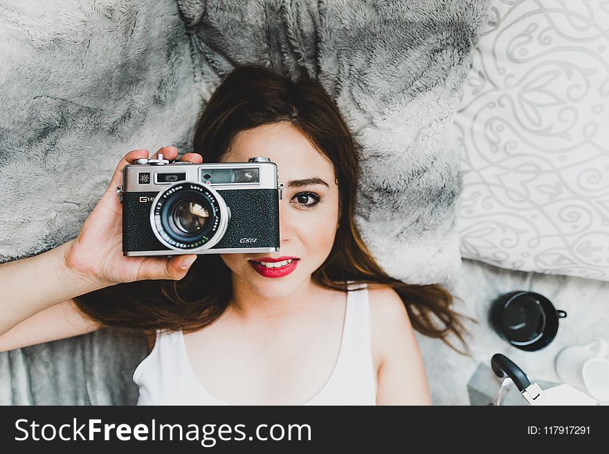 Woman Wearing White Tank Top Holding Black Camera