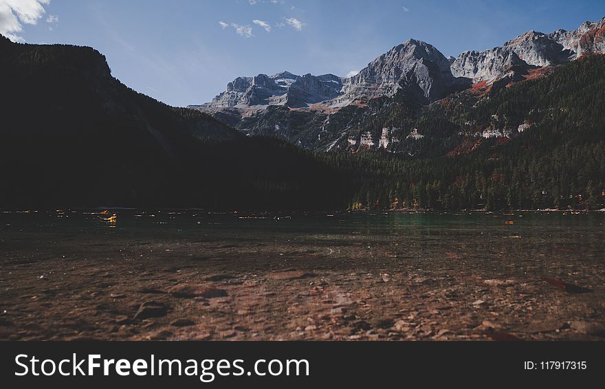 Body Of Water Beside Mountain