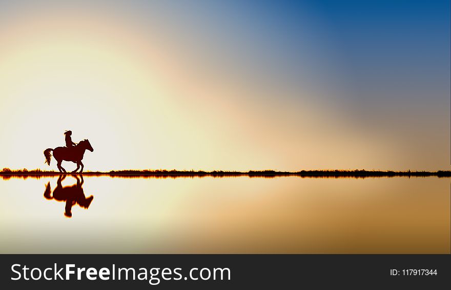 Silhouette Of Person Riding A Horse