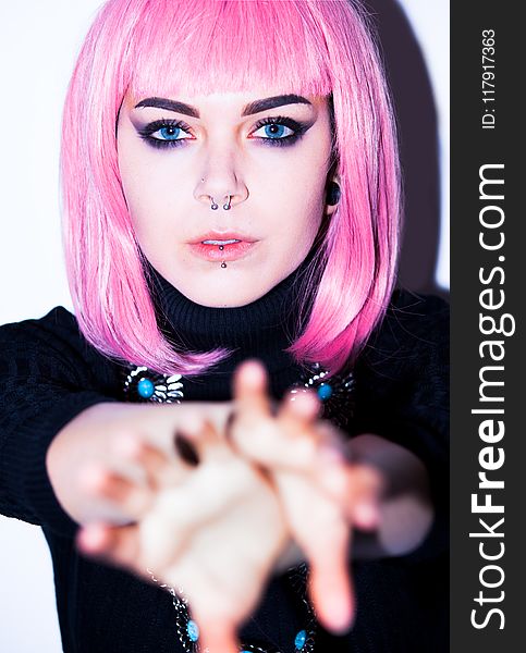 Pink Haired Woman Wearing Black Shirt With Nose And Lip Piercings
