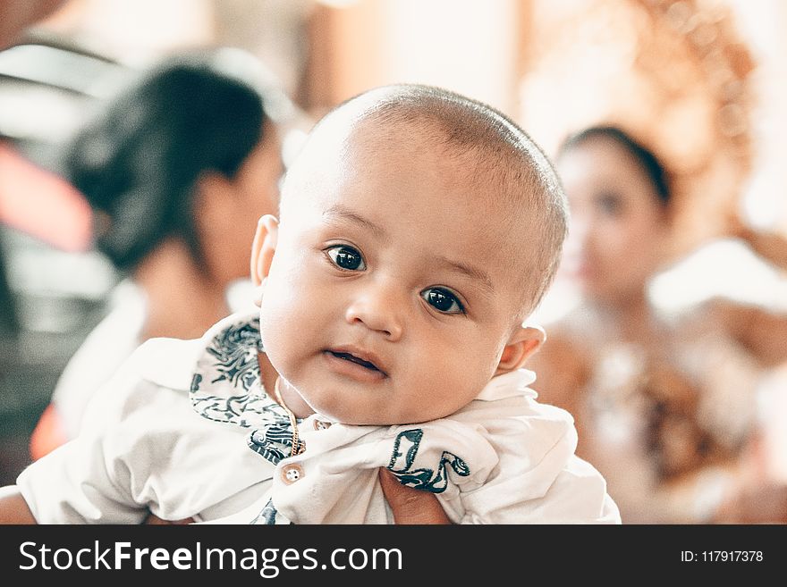 Baby In White Top In Tilt Shift Lens Shot