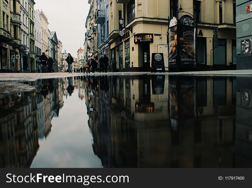 Reflection Of Buildings On Puddle