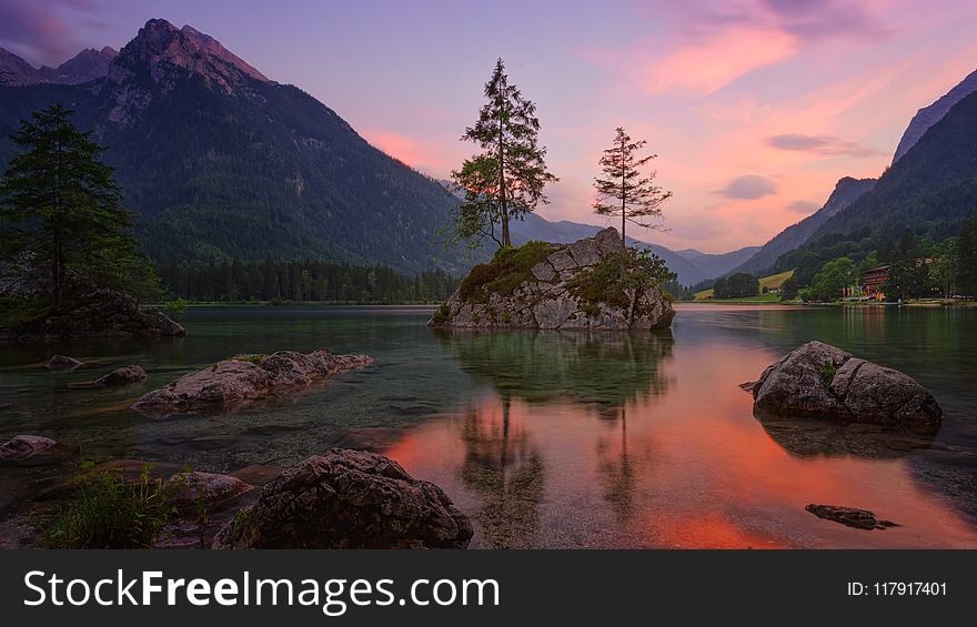 Lake Surrounded By Mountains During Golden Hour